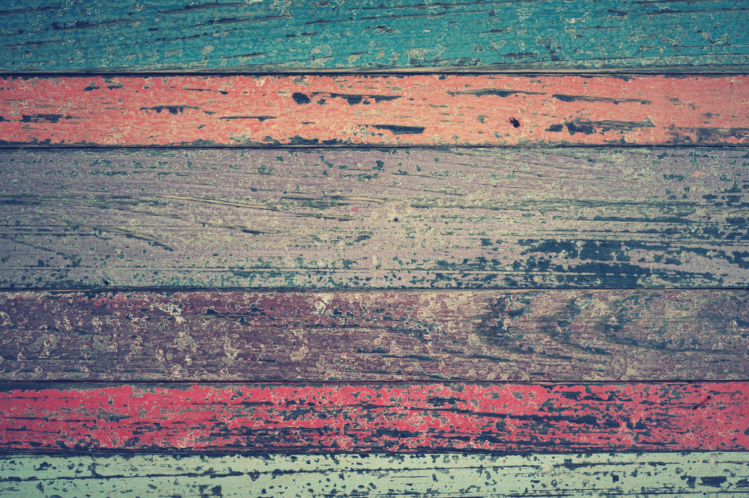 Vibrant, rustic wooden planks with a worn, weathered texture create a unique design.